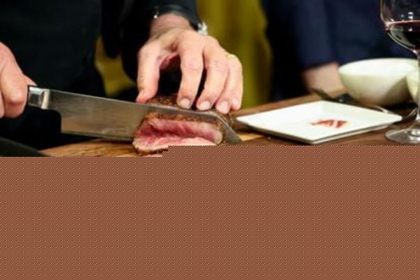 Wolfgang Puck presents one of the cuts of meat that will be served at the Governors Ball, the Academy Awards after party.